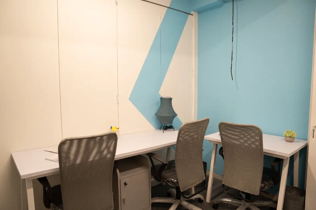 Teloz Spaces private office with light blue accent wall